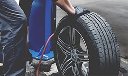 Technician filling new tire